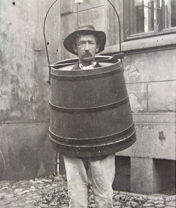 Man trapped in a large wooden barrel device, demonstrating one of the shocking t*****e methods from medieval history.