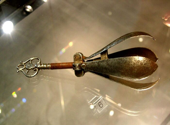 Medieval t*****e device with metal clamps and screws used for inflicting pain from shocking t*****e methods and devices history.