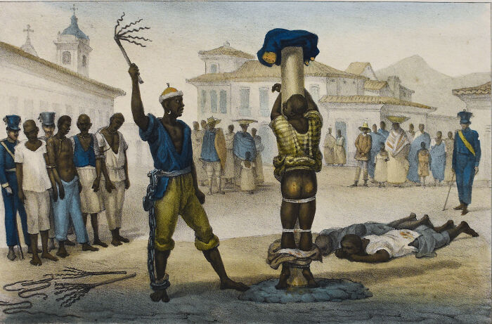 Medieval t*****e methods showing a man whipped while tied to a post before a gathered crowd in a town square.